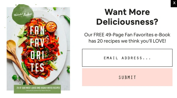 Minimalist Baker's Fan Favorites e-book cover, showcasing a vibrant dish with peppers, limes, and sauce. A pop-up form asks for an email address to receive the free e-book.