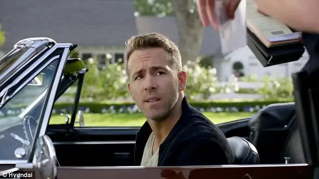 ryan reynolds sitting in a car in a hyundai commercial, showcasing the authority bias. the image depicts how the authority of a celebrity can influence consumer behaviour, making them more likely to purchase a product that the celebrity endorses.