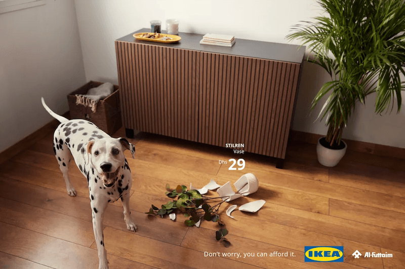 A Dalmatian stands next to a broken vase and potted plant on a wooden floor, an emotional marketing ad.